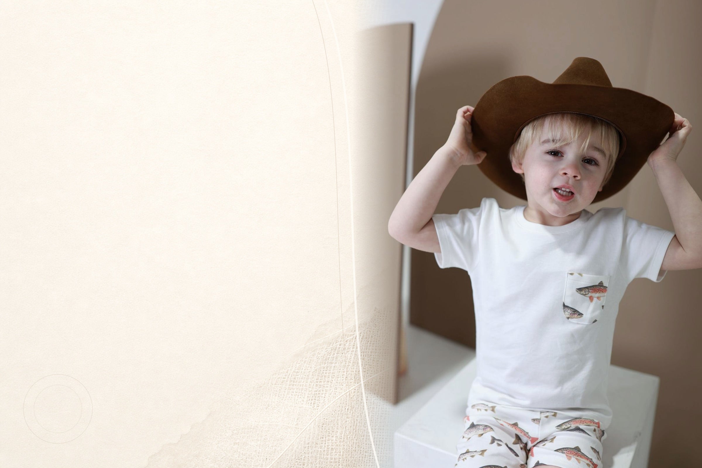 Child wearing the Gone Fishin Pima set beside a soft cotton-inspired graphic